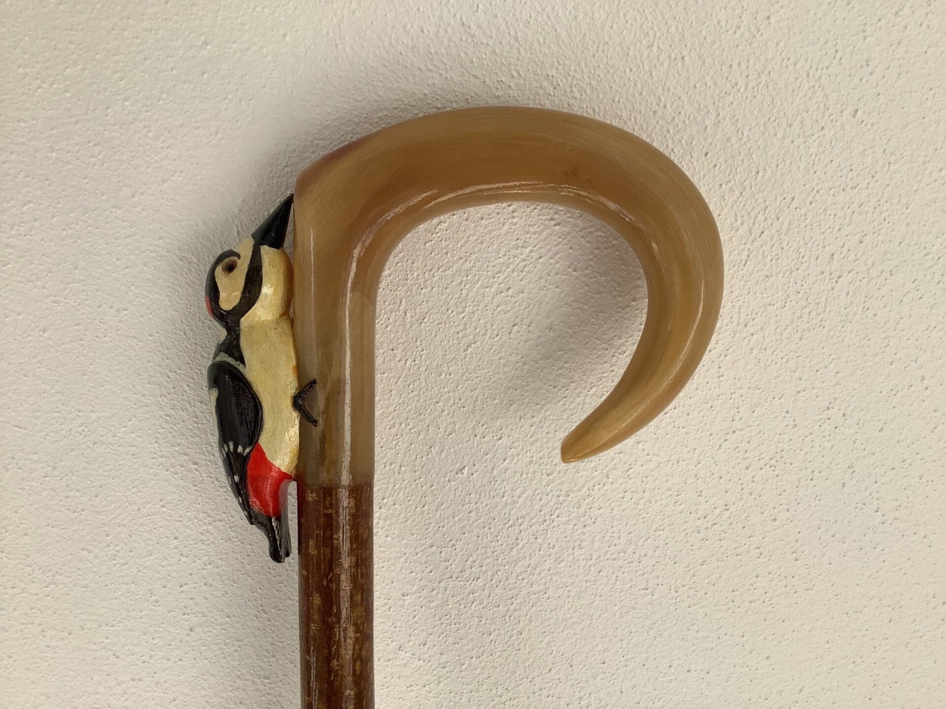 A lineup of finished walking sticks at a display